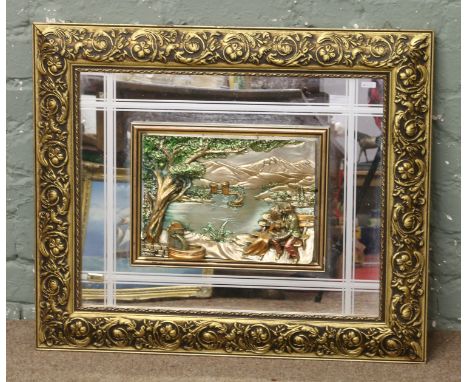 An ornate gilt framed mirror with silver filled panel, lovers scene and Italian makers mark.