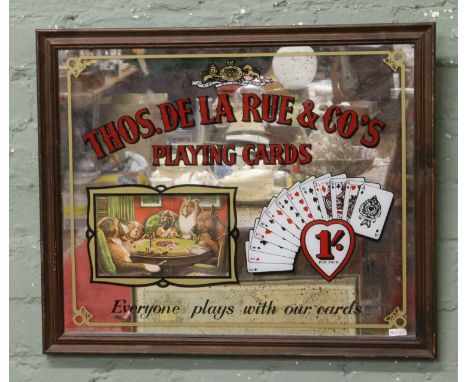 A framed advertising mirror for Thomas De La Rue & Co. playing cards.