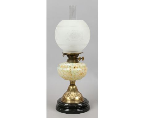 A Victorian brass based oil lamp with frosted glass shade.