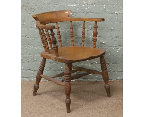 A Victorian smokers bow armchair.