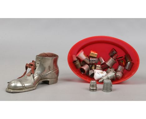 A silver plate boot shaped pin cushion and collection of thimbles and miniature ornaments.