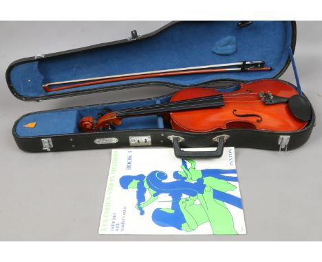 A cased Skylark brand violin and bow along with violin method book 1. Condition Report. To be used as a guide only. Case hing