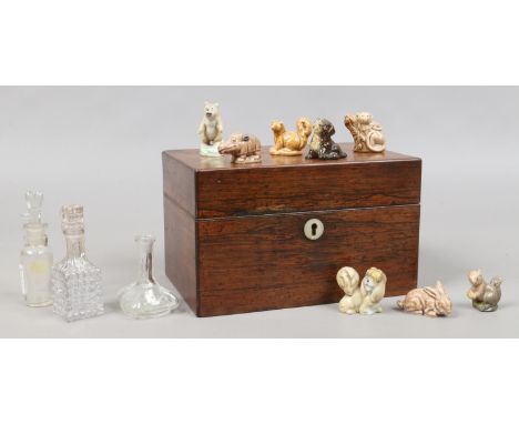 A Georgian rosewood tea caddy along with a quantity of Wade Whimsies, miniature antique glass storage vessels.