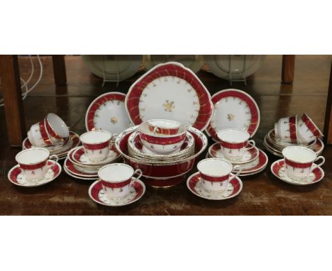 A Staffordshire New Chelsea tea service with gilt and claret borders together with a similar Royal Worcester fruit set.