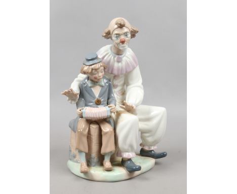 A boxed large Nao figure of a clown and clown boy.