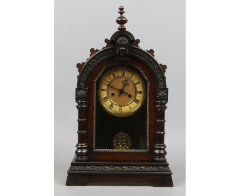 An early C20th ornate mantel clock with two train movement, pendulum and key.