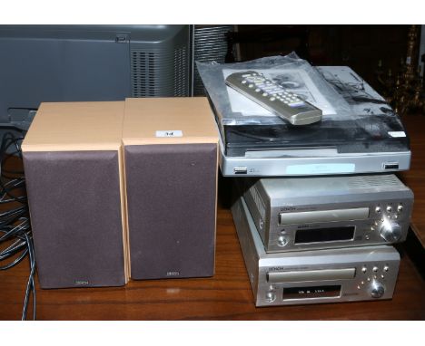 A Denon mini stacking music system and pair of speakers, along with a mini turn table with remote and manual.