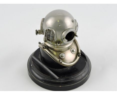 An early 20th century novelty inkwell in the form of a six bolt diver's helmet, white metal opening at the neck to reveal ink