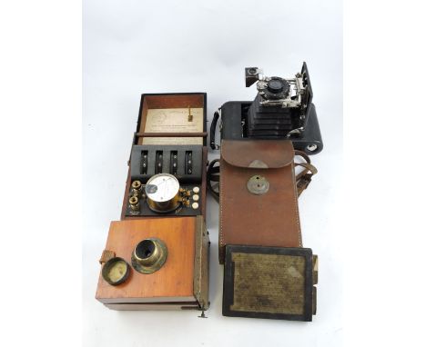 An early 20th century Ansco bellows camera, tan leather case; together with a mahogany plate camera, and a mahogany cased Whe