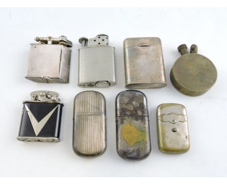 A George V engine-turned silver petrol lighter, Birmingham 1919, together with an early 20th century white metal petrol light