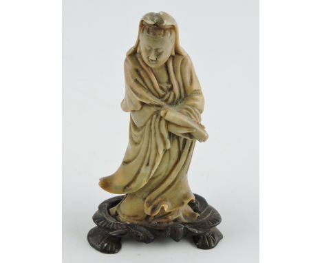 A Chinese carved soapstone figure of a scholar, flowering robes with a scroll, mounted on a wooden base, H. 13cm.