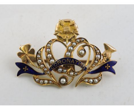 An early 20th yellow metal, seed pearl and enamel Coronation brooch.