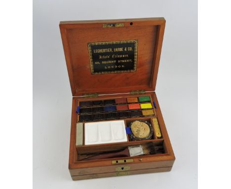 A late Victorian mahogany artist's box by Lechertier, Barbe & Co., London, fully fitted with paints, ceramic palette, brushes