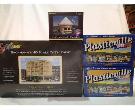 Three Bachmann HO scale building kits, comprising department store, and two railroad work sheds, plus cast model of ice cream