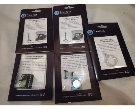 Train Tech OO scale, two buffer stop lights, automatic tail light, arc welding light, and signal controller, all as new, ex s