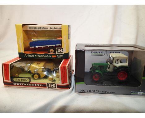1/32 scale farming vehicles comprising, Duetz Fahr D.60 tractor with cabin, near mint and boxed, plus Britians hay baler and 