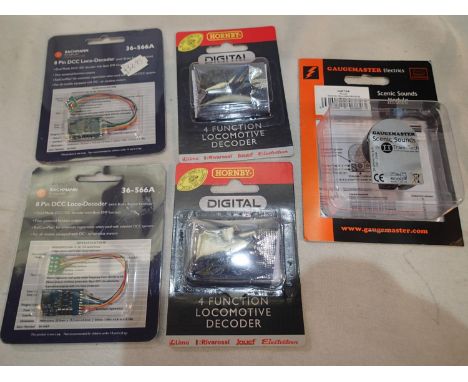 Four decoders, comprising two Hornby four locomotives, two Bachmann 8 pin locomotives, and one Gaugemaster scenic sounds modu