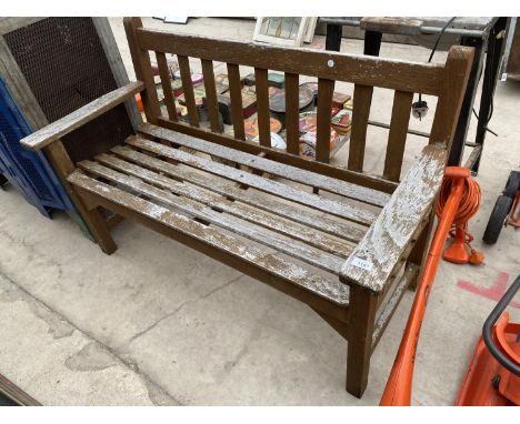 A WOODEN GARDEN BENCH 