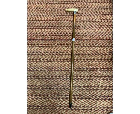 A WALKING STICK WITH A BONE HANDLE AND A POSSIBLY SILVER FINIAL 