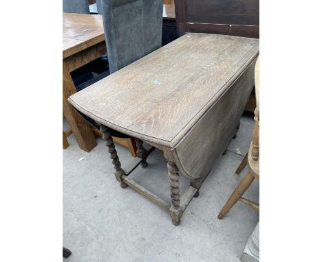 AN EARLY TWENTIETH CENTURY OAK BARLEY TWIST GATE LEG TABLE 