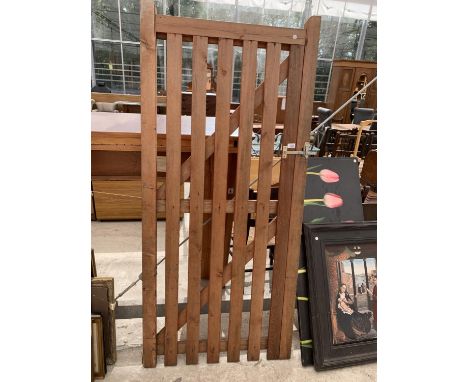 A WOODEN GATE WITH LATCH 