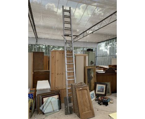 A TWENTY-EIGHT RUNG TWO SECTION ALLOY LADDER WITH A STAND OFF 
