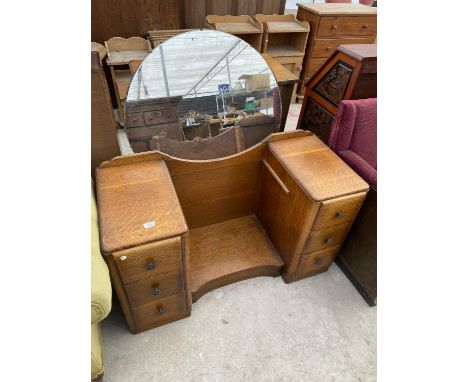 AN ART DECO STYLE OAK DRESSING TABLE WITH SIX DRAWERS AND CIRCULAR MIRROR 