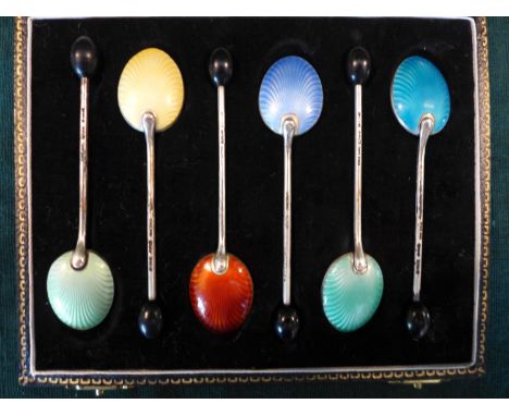 A CASED SET OF SIX SILVER COFFEE BEAN SPOONS, THE BACKS WITH MULTI COLOURED ENAMEL DECORATION 
