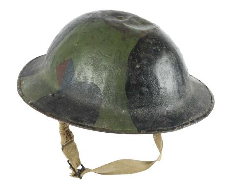 A British brodie steel helmet, painted with black and green camouflage and with a formation sign of a diamond divided red and