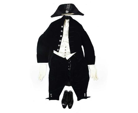A British court uniform, comprising: velvet tailcoat with cut steel buttons and corresponding knee breeches, bicorn hat with 