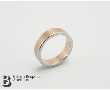 A platinum and 18ct rose gold bespoke wedding band, size P, weight approx. 9.65gms.The outside band of the ring is crafted fr