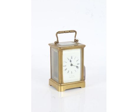 Gilt brass carriage clock, the white enamel dial with black roman numerals, the dial signed "Farnham, Lyme Regis", with key, 