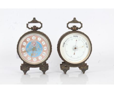 Early 20th century brass cased clock and barometer set, the clock having pink, white and blue enamel dial with roman numerals