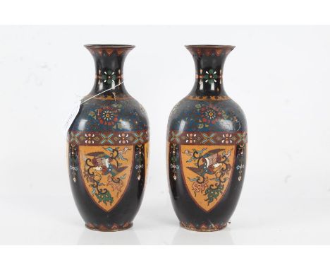 Pair of Japanese cloisonne vases, Meiji period, with foliate decoration within a shield shaped cartouche on navy blue ground,