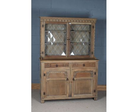 Light oak dresser by Stanley Wood of Olney, Buckinghamshire, the twin lead glazed doors above two frieze drawers and two pane