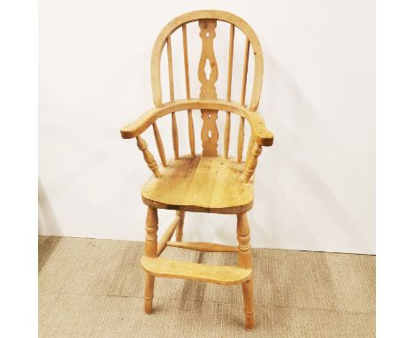 A light oak spindle back child's high chair, H. 96cm.