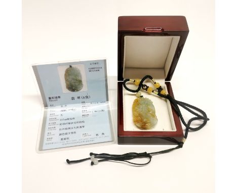 A lovely Chinese carved jade amulet, L. 5cm, with certificate.