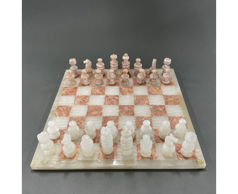 A polished onyx chess set and board, 36 x 36cm.