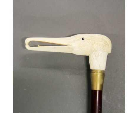 A carved bone seagull head handle walking stick, cane L. 87cm, seagull head L. 14cm.