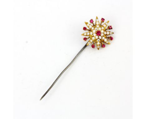 A yellow and white metal stick pin set with round cut rubies and white stones, L. 7.1cm.