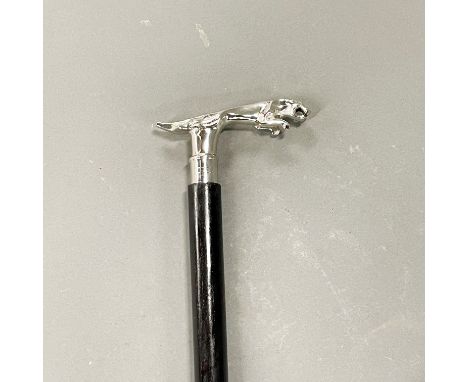 A walking stick with jaguar style handle.