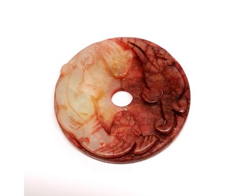 A small Chinese carved jade disc, dia. 5.5cm.