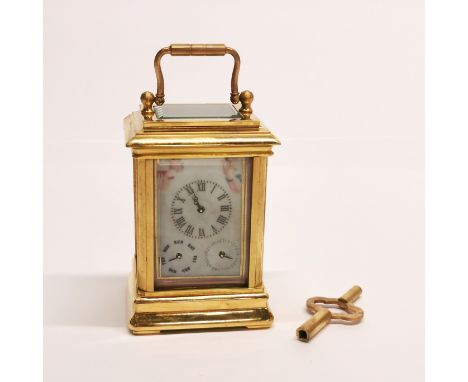 A miniature gilt brass and porcelain carriage clock, H. 10cm.