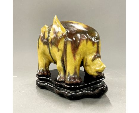 A rare Chinese glazed ceramic figure of a six legged mythical animal (Dijiane) with a purpose made carved wooden stand, H. 17
