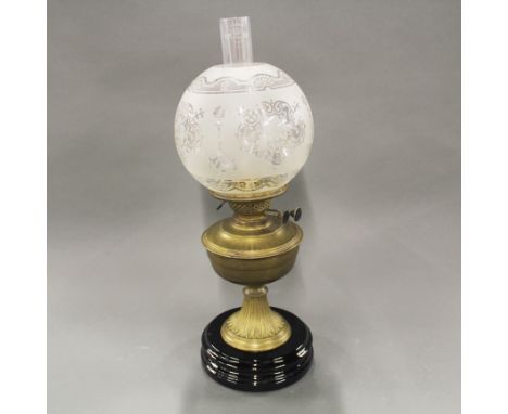 A Victorian brass oil lamp with ceramic base, H. 55cm.