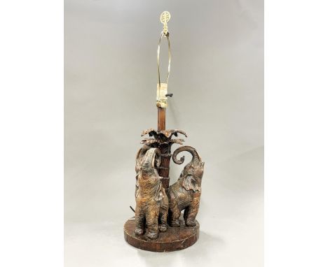 An carved wood effect vintage elephant table lamp, H. 69cm.