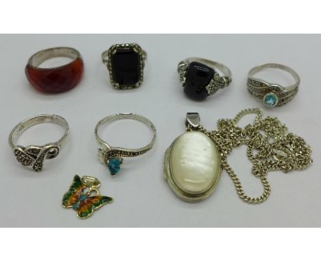 Six silver rings, a silver locket and chain and an enamel butterfly pendant