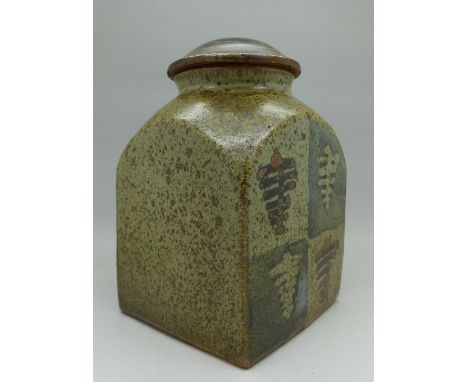 A Bernard Leach stoneware jar and cover, square form with arched shoulders, with foliate to two sides, with two clear impress