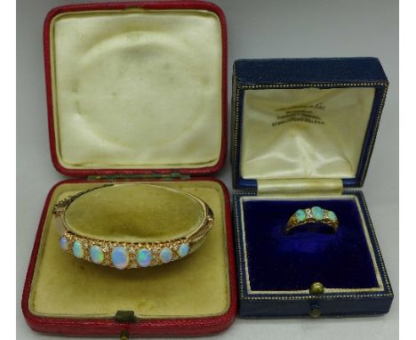 An 18ct gold, opal and white stone ring, 3.9g, Q, and a yellow metal and synthetic opal bangle, 12.9g