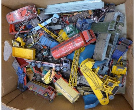 A box of Dinky Supertoys, playworn vehicles including Pullmore Car Transporter, Elevator Loader, Cadillac Eldorado, Foden lor